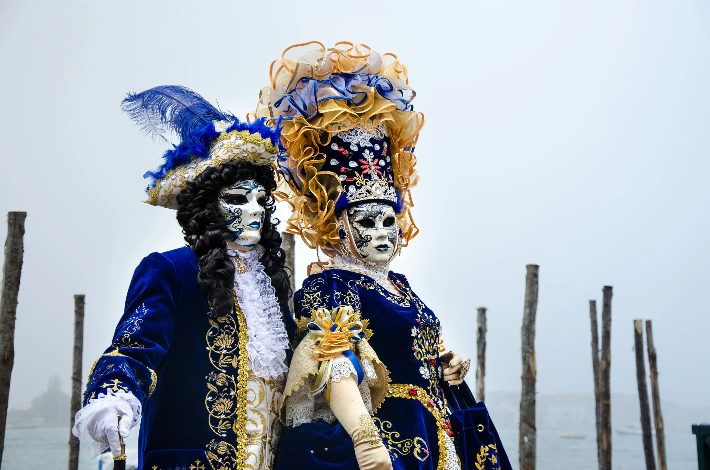 a couple of people that are standing next to each other, by Federico Zuccari, pexels contest winner, baroque, costume with blue accents, gondolas, ghost mask, square