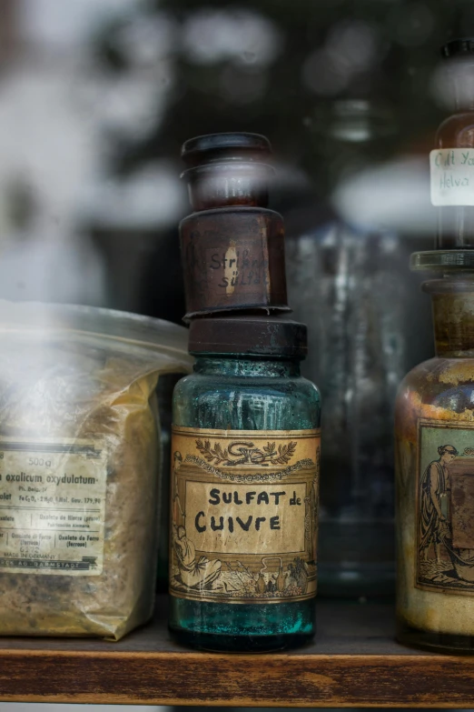 a bunch of bottles that are on a shelf, sulfur, cabinet of curiosities, medical labels, close shot