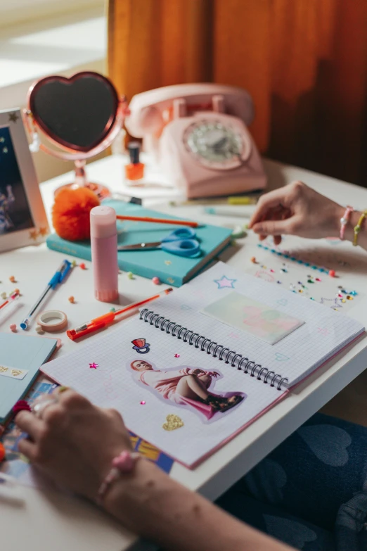 a woman sitting at a desk working on a project, a child's drawing, by Julia Pishtar, trending on pexels, glitter sticker, teenage girl, official artbook, glitter accents on figure