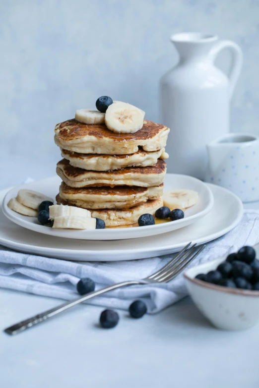 a stack of pancakes sitting on top of a white plate, a portrait, unsplash, clumps of bananas, blueberries on the side, thumbnail, 6 pack