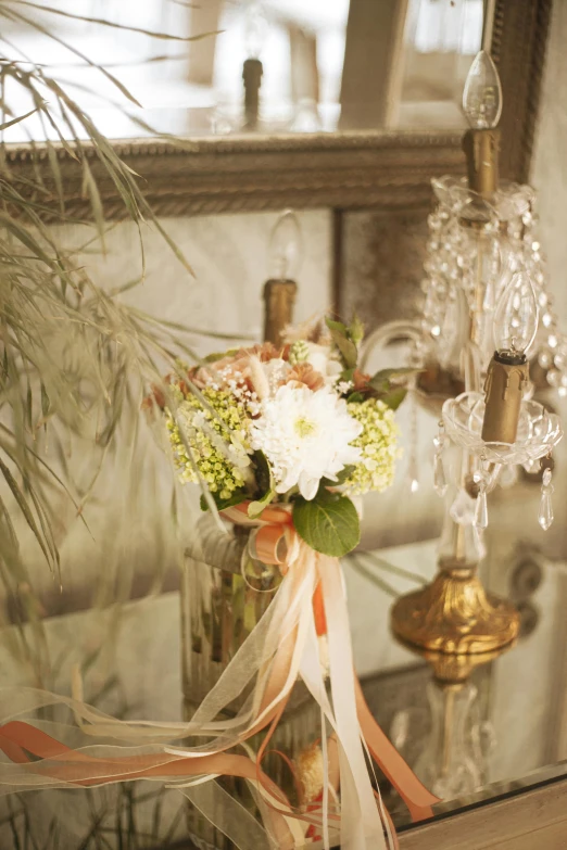 a vase filled with flowers sitting on top of a table, sconces, detail shot, bouquet, fully decorated