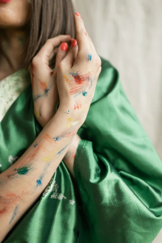 a woman with paint all over her hands, an album cover, inspired by Helen Frankenthaler, trending on pexels, visual art, japanese kimono, crossed arms, medium close up, hindu aesthetic