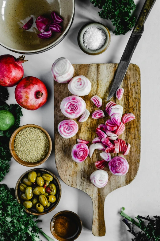 a cutting board with a bunch of vegetables on it, by Lisa Milroy, featuring pink brains, middle eastern details, products shot, onion