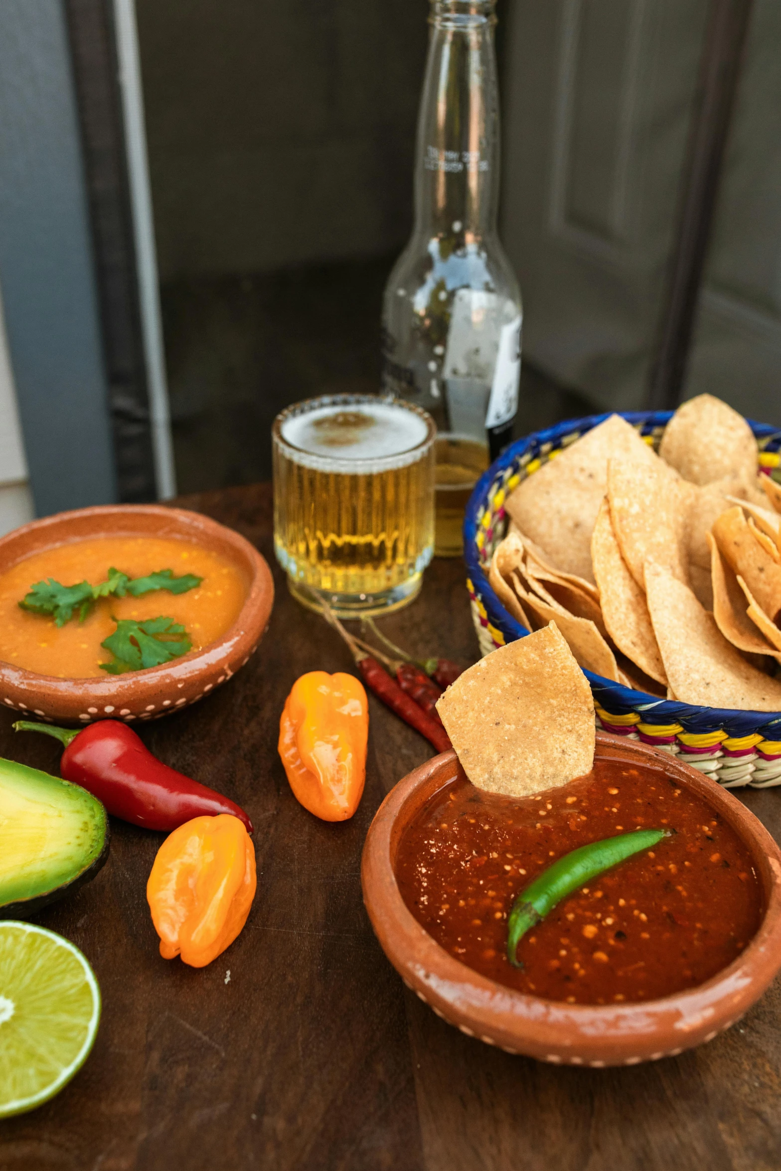 a wooden table topped with bowls of salsa and tortillas, a still life, pexels contest winner, dau-al-set, beers on the table, in house, gold, medium close shot