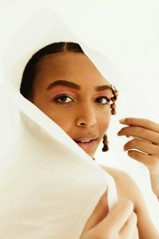 a woman with a veil covering her face, an album cover, by Olivia Peguero, alexandria ocasio-cortez, photoshoot for skincare brand, lovingly looking at camera, african american young woman