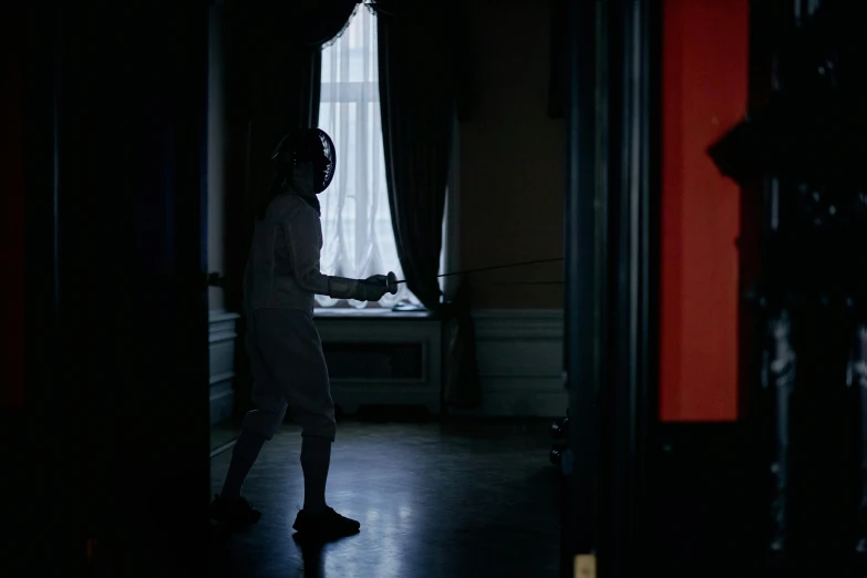 a woman standing in a dark room in front of a window, happening, fencing, tournament, tv still, ignant