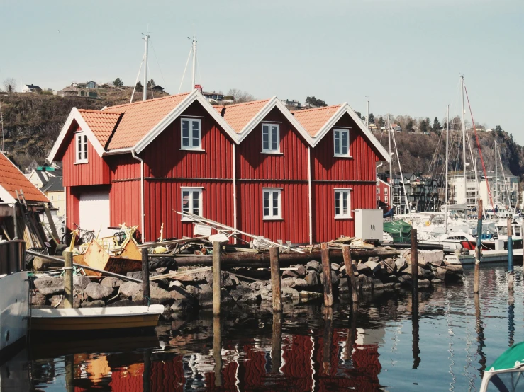 a number of boats in a body of water, a picture, inspired by Wilhelm Marstrand, pexels contest winner, hurufiyya, red building, hygge, 🦩🪐🐞👩🏻🦳, seen from outside