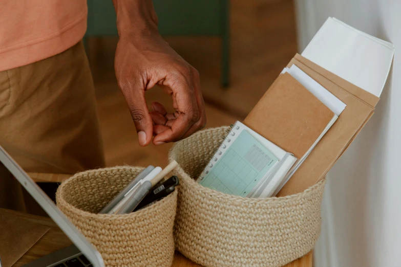 a man standing in front of a laptop computer, trending on pexels, with an easter basket, sustainable materials, neutral colours, diary on her hand