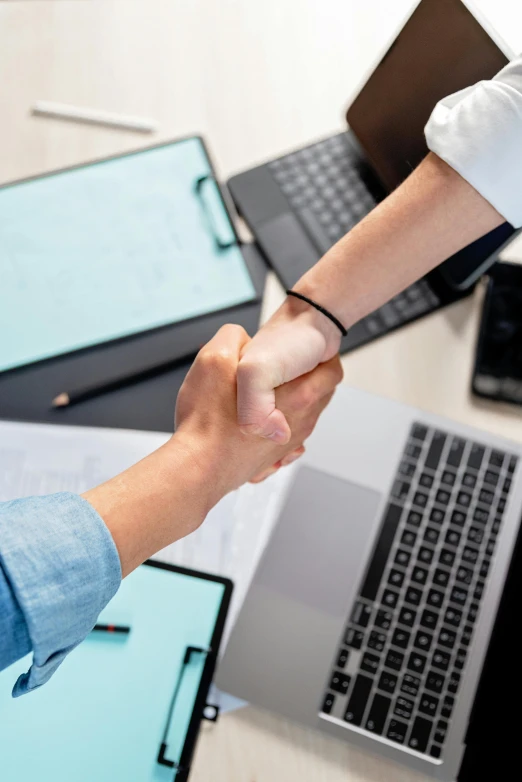 two people shaking hands in front of laptops, pexels contest winner, renaissance, healthcare, thumbnail, multiple stories, colour corrected