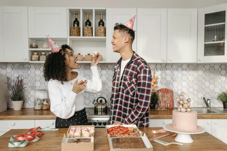 a man and a woman standing in a kitchen, pexels contest winner, happening, barbarian celebrate his birthday, background image, snacks, profile image