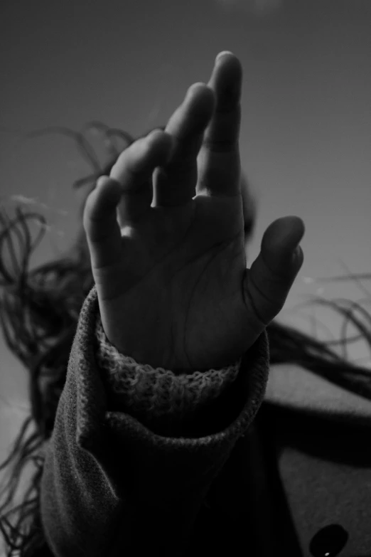 a black and white photo of a person with their hand in the air, inspired by Max Dupain, long fingernails, dread, (((intricate))), end of the day