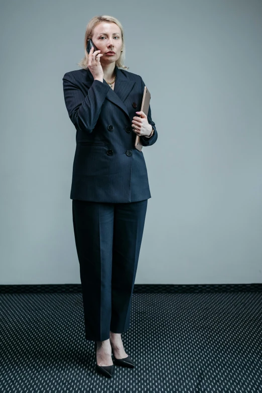 a woman in a suit talking on a cell phone, an album cover, by Matthias Stom, pexels, standing, worried, 15081959 21121991 01012000 4k, office clothes