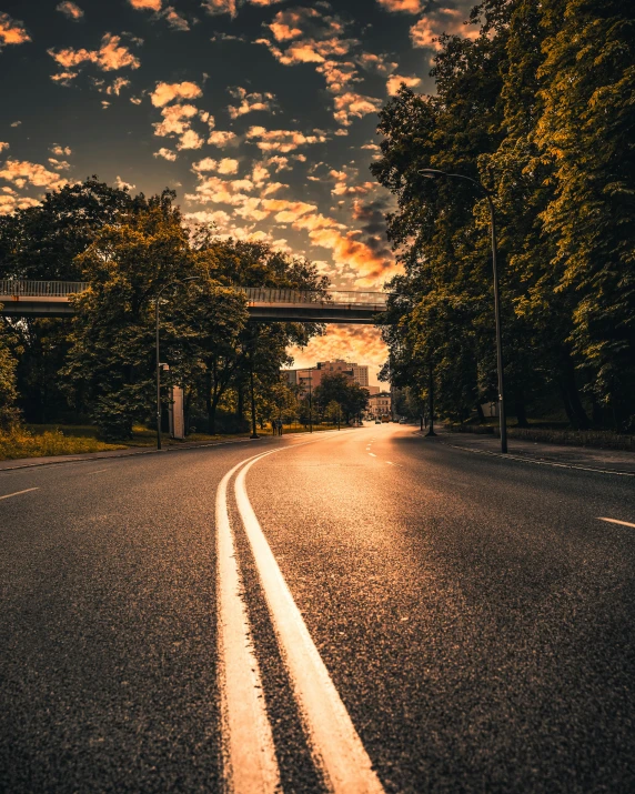 an empty road with a bridge in the distance, pexels contest winner, lgbtq, instagram story, golden hour photo, curves