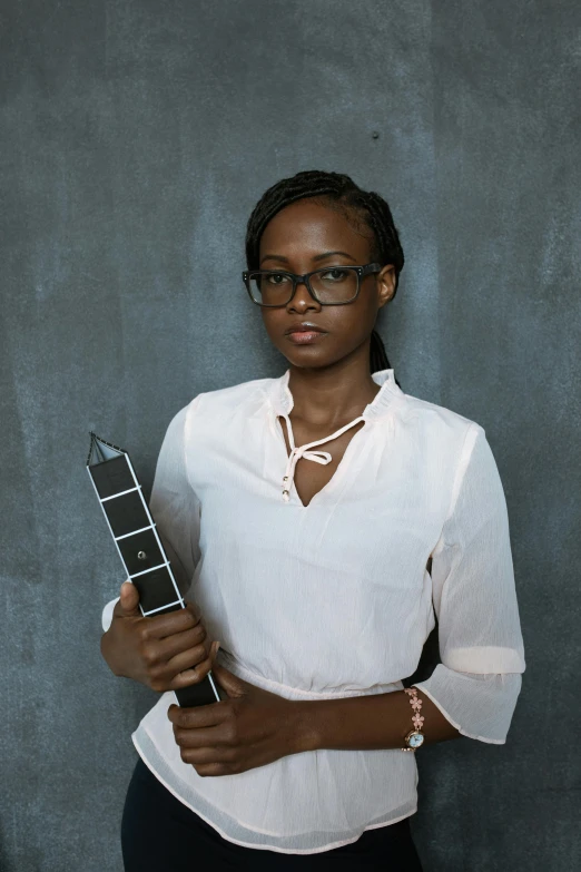 a woman in a white shirt holding a guitar, an album cover, inspired by Chinwe Chukwuogo-Roy, holding an activated lightsaber, wearing square glasses, professional award winning photo, portrait n - 9