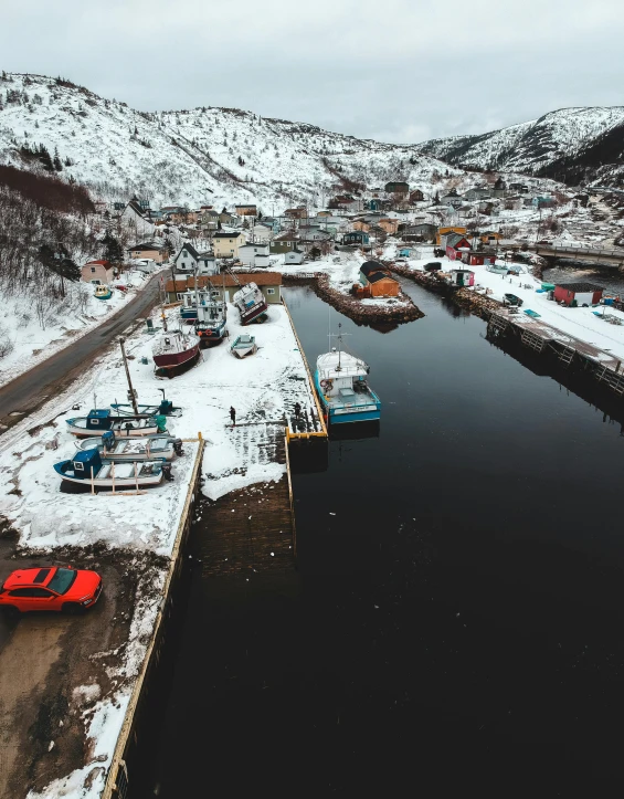 a body of water surrounded by snow covered mountains, small port village, best photo, thumbnail, flatlay