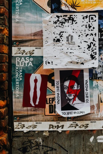 a bunch of posters on the side of a building, a poster, by Micha Klein, trending on pexels, street art, beautiful labels, mixed materials, russian constructivism, svg sticker art