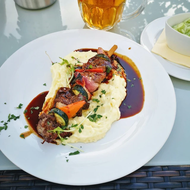 a close up of a plate of food on a table, half goat, at the terrace, profile image, biedermeier