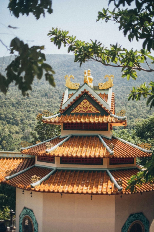 a pagoda sitting on top of a lush green hillside, inspired by Ni Duan, trending on unsplash, cloisonnism, 2 5 6 x 2 5 6 pixels, vietnamese temple scene, guan yu, as seen from the canopy