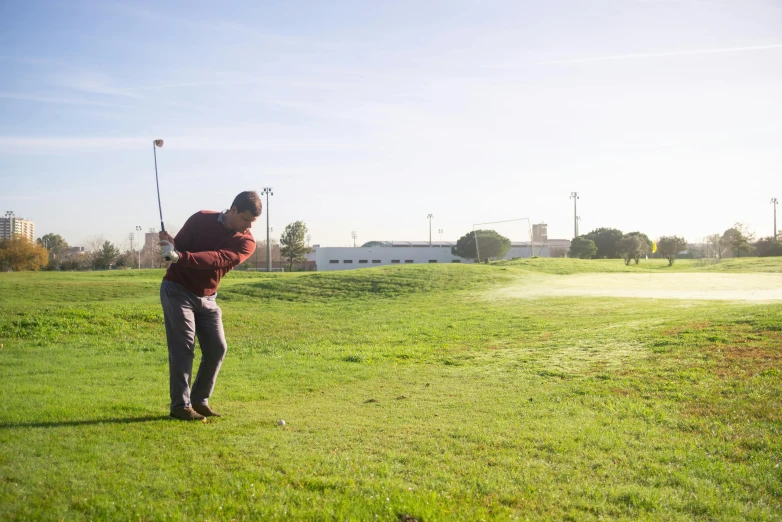 a man that is standing in the grass with a golf club, happening, schools, albuquerque, swings, bay area