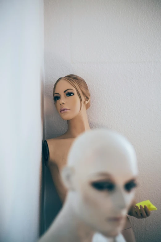 a woman standing in front of a mirror next to a mannequin, a surrealist sculpture, inspired by Elsa Bleda, unsplash, neo-figurative, portrait of female android, cross section of mannequin head, a blond, hiding