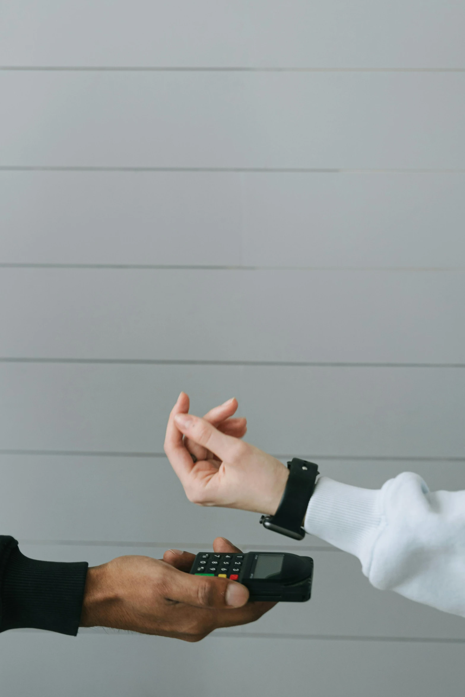 a man handing another man a cell phone, by Carey Morris, trending on pexels, minimalism, witch paying for her sins, scaled arm, in office, on a gray background