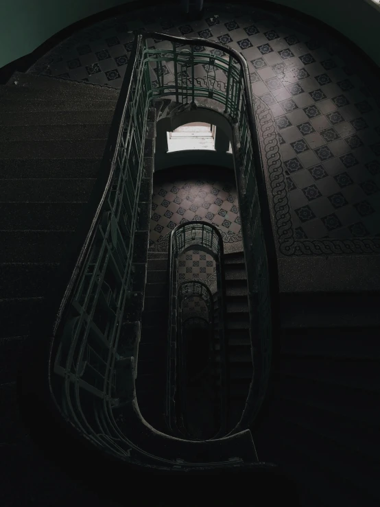 a spiral staircase leading to the top of a building, inspired by Elsa Bleda, unsplash contest winner, art nouveau, dark eerie photo, ✨🕌🌙, room of a dark mansion, museum photo