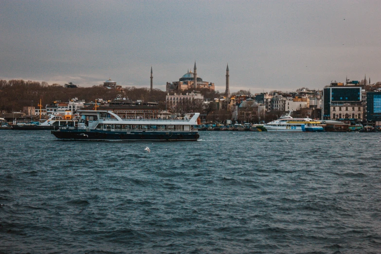 a group of boats floating on top of a body of water, by Ismail Acar, pexels contest winner, hurufiyya, istanbul, 256x256, grayish, brown