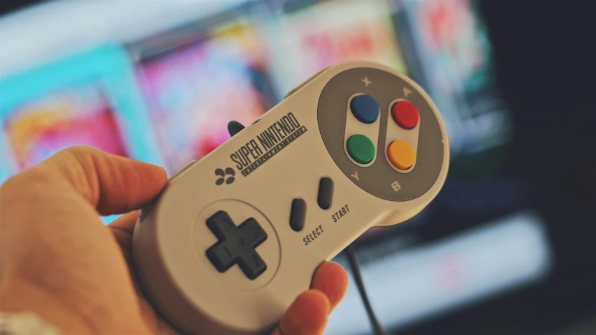 a close up of a person holding a game controller, inspired by Mario Cooper, unsplash, neogeo, super nintendo, instagram post, desaturated, gaming room