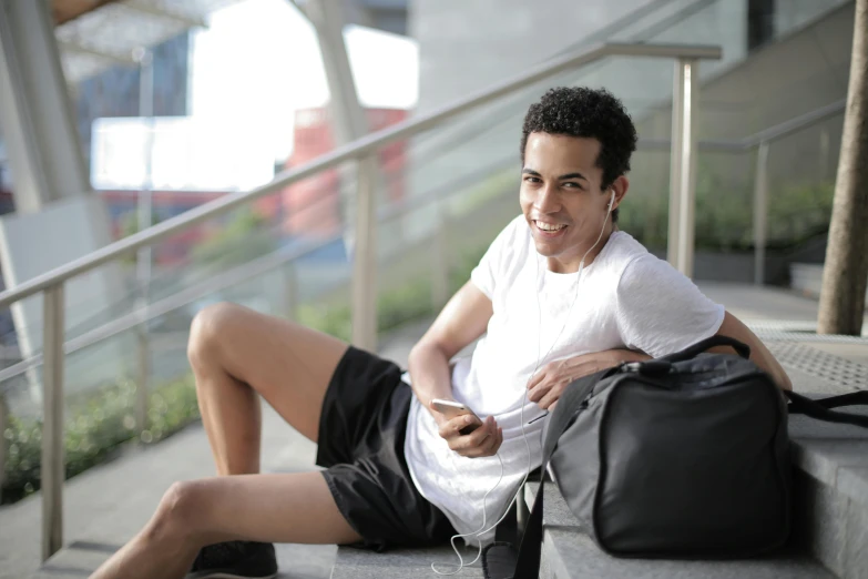 a man that is sitting down with a bag, pexels contest winner, happening, lean man with light tan skin, black teenage boy, middle eastern skin, sport clothing