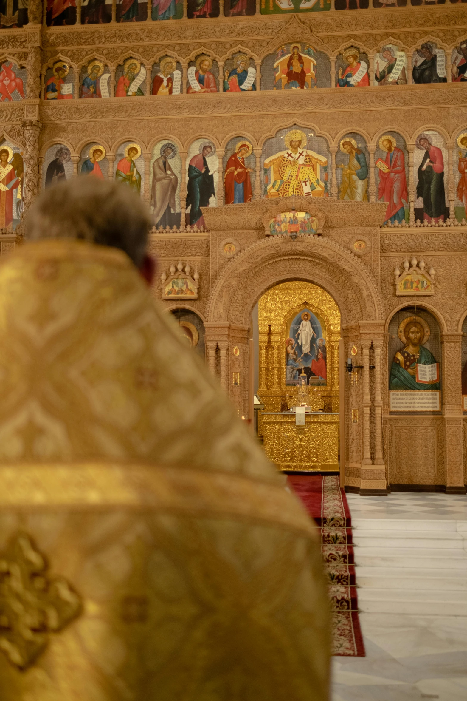 a priest standing in front of a golden altar, orthodoxy, slide show, facing away from the camera, zoomed out to show entire image