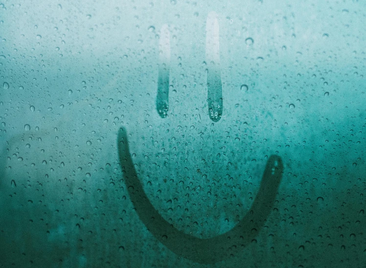 a rain covered window with a smiley face drawn on it, an album cover, inspired by Elsa Bleda, trending on pexels, hurufiyya, happy expressions, christopher shy, techno-optimism, crying big blue tears