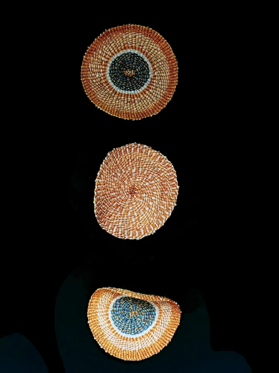 a group of baskets sitting on top of a table, by Jan Rustem, hurufiyya, on black background, fairy circles, triptych, view from below