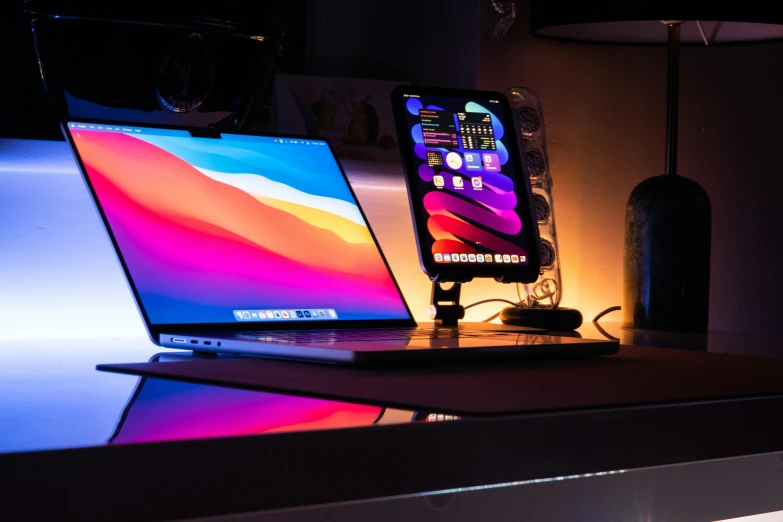 a laptop computer sitting on top of a desk, pexels, thin glowing devices, colourful lighting, floating monitors, profile picture 1024px