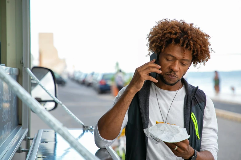 a man standing next to a food truck talking on a cell phone, pexels contest winner, renaissance, curly afro, battered, oceanside, lil uzi vert