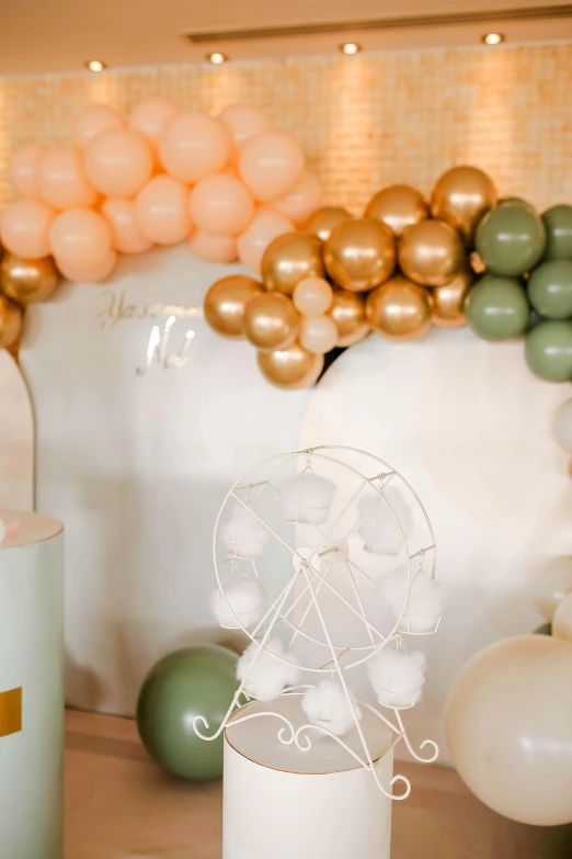 a bunch of balloons sitting on top of a table, green and warm theme, ornate backdrop, muted colours, for junior