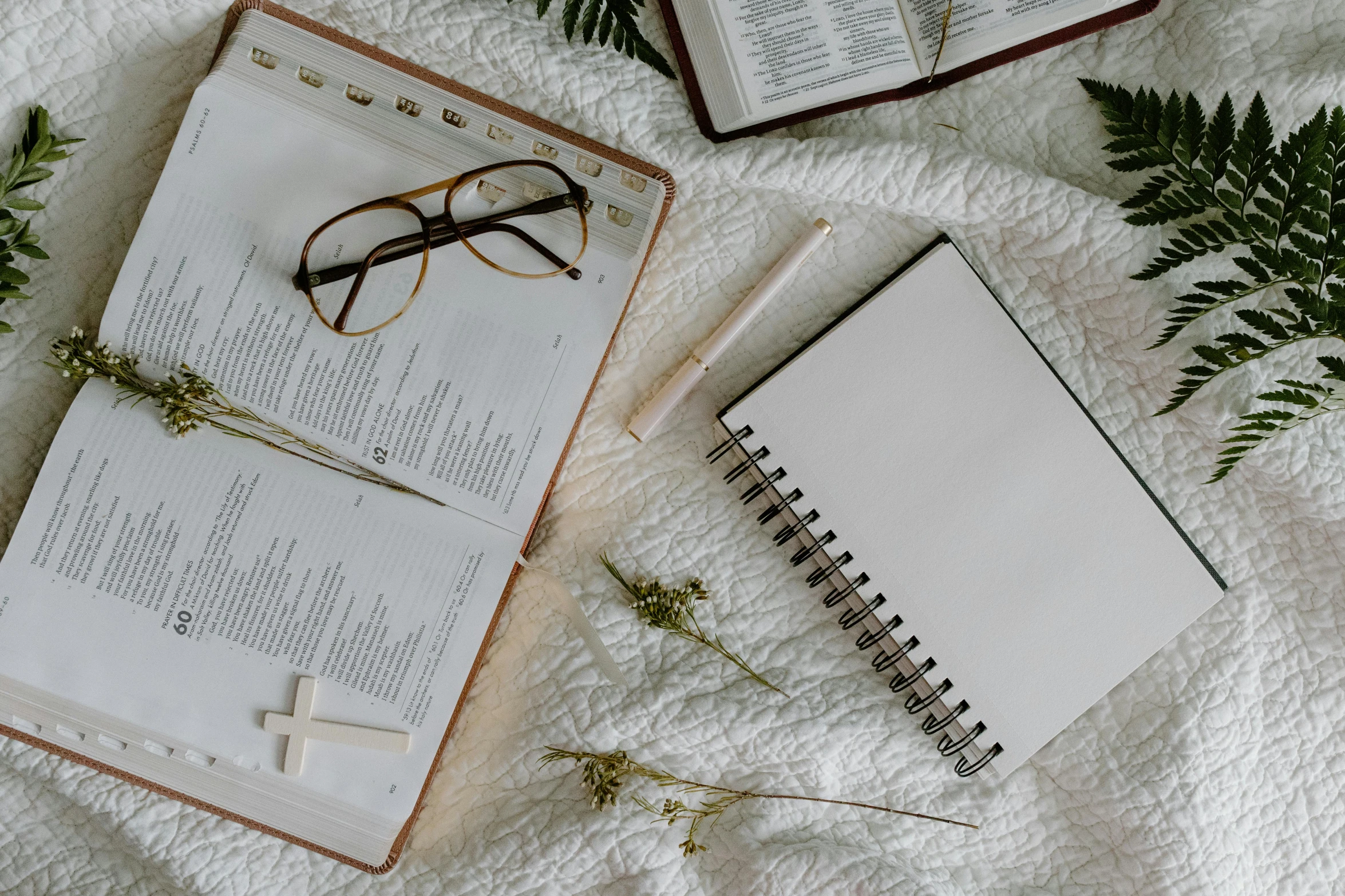 an open book sitting on top of a bed next to a pair of glasses, trending on pexels, happening, white church background, white sketchbook style, background image