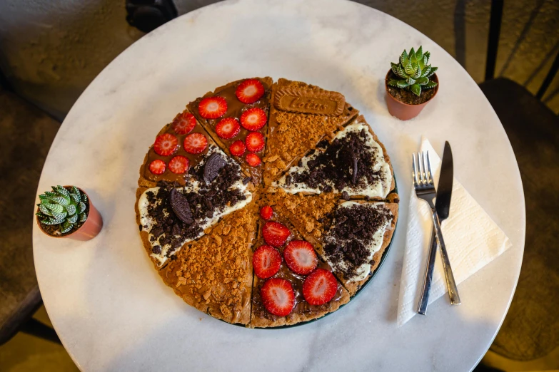 a pizza sitting on top of a table next to a knife and fork, fully chocolate, crackles, utrecht, healthy