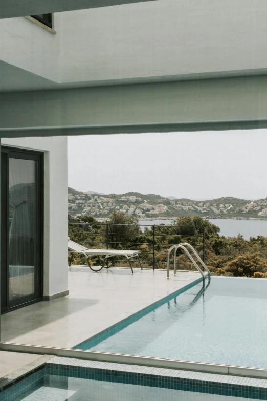 a swimming pool with a view of the ocean, a picture, by Exekias, unsplash contest winner, modernism, hills, balcony door, 4 k cinematic panoramic view, medium long shot