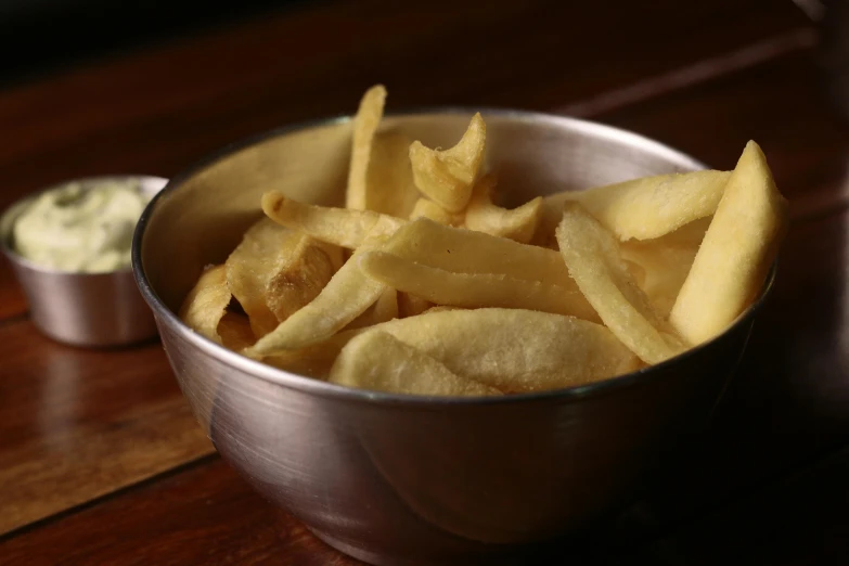 a bowl of french fries sitting on top of a wooden table, silver, outback, small, image