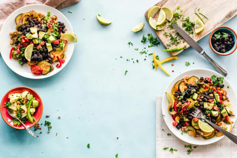 a table topped with plates of food next to a cutting board, by Carey Morris, pexels contest winner, avacado chairs, veggies, profile image, ratatouille style