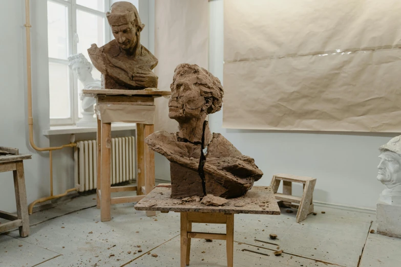 a couple of sculptures sitting on top of a table, arbeitsrat für kunst, portait image, thumbnail, clay material, during the day
