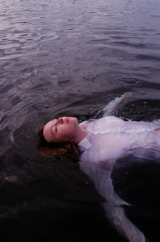 a woman floating on top of a body of water, inspired by Elsa Bleda, unsplash, renaissance, sadie sink, mournful, ignant, taken in 1 9 9 7