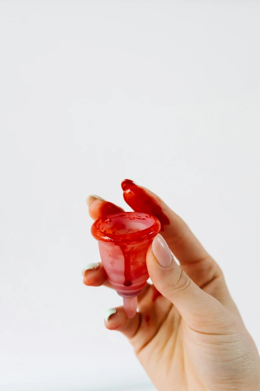 a person holding a red object in their hand, jello, bong, detailed product shot, multi-part