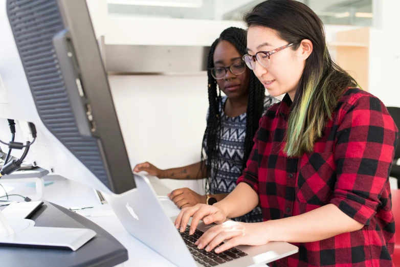 two women working on a laptop in an office, computer graphics, by Carey Morris, trending on unsplash, louise zhang, programmer, student, in front of a computer