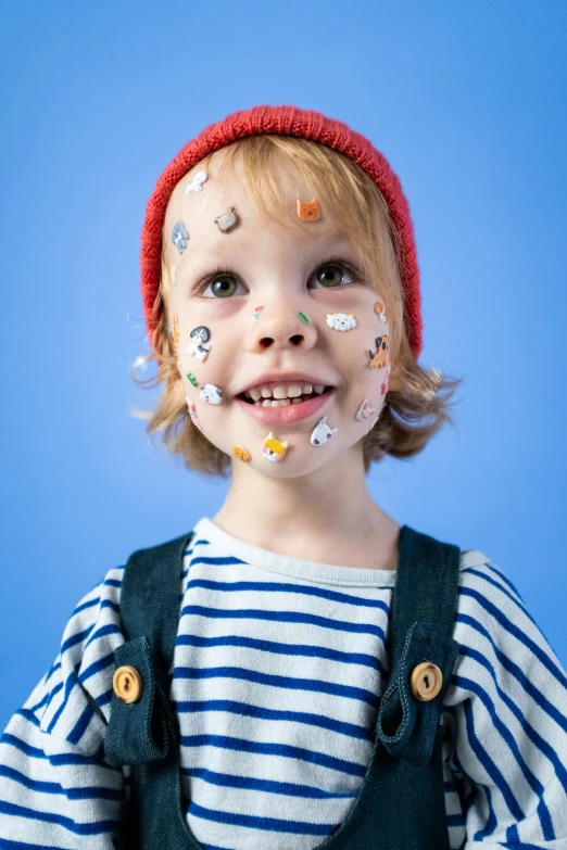 a little boy with paint all over his face, a child's drawing, by Ellen Gallagher, trending on pexels, made of dots, stickers, face accessories, pixar portrait 8 k photo