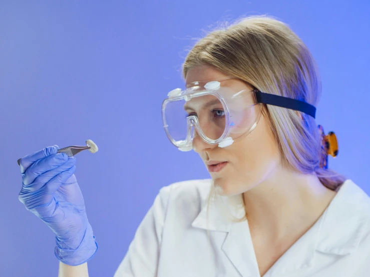 a close up of a person in a lab coat and goggles, trending on pexels, analytical art, female investigator, plating, profile pic, holding a crowbar