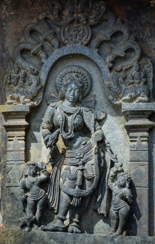 a statue of a woman holding a child, a statue, hurufiyya, cybertronic hindu temple, intricate scrollwork, in the center of the image, very detaile