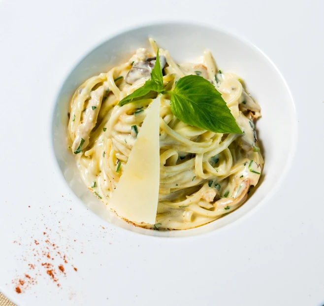 a plate of pasta with mushrooms and parmesan cheese, by Carlo Martini, pexels contest winner, pale greens and whites, on white, basil, made of spaghetti