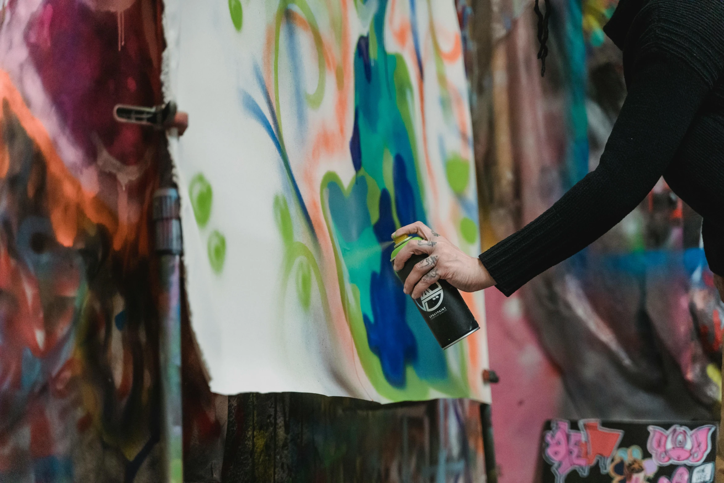 a person painting on a wall with a spray can, an airbrush painting, by Julia Pishtar, pexels contest winner, paper marbling, on a canva, full view with focus on subject, black graffiti