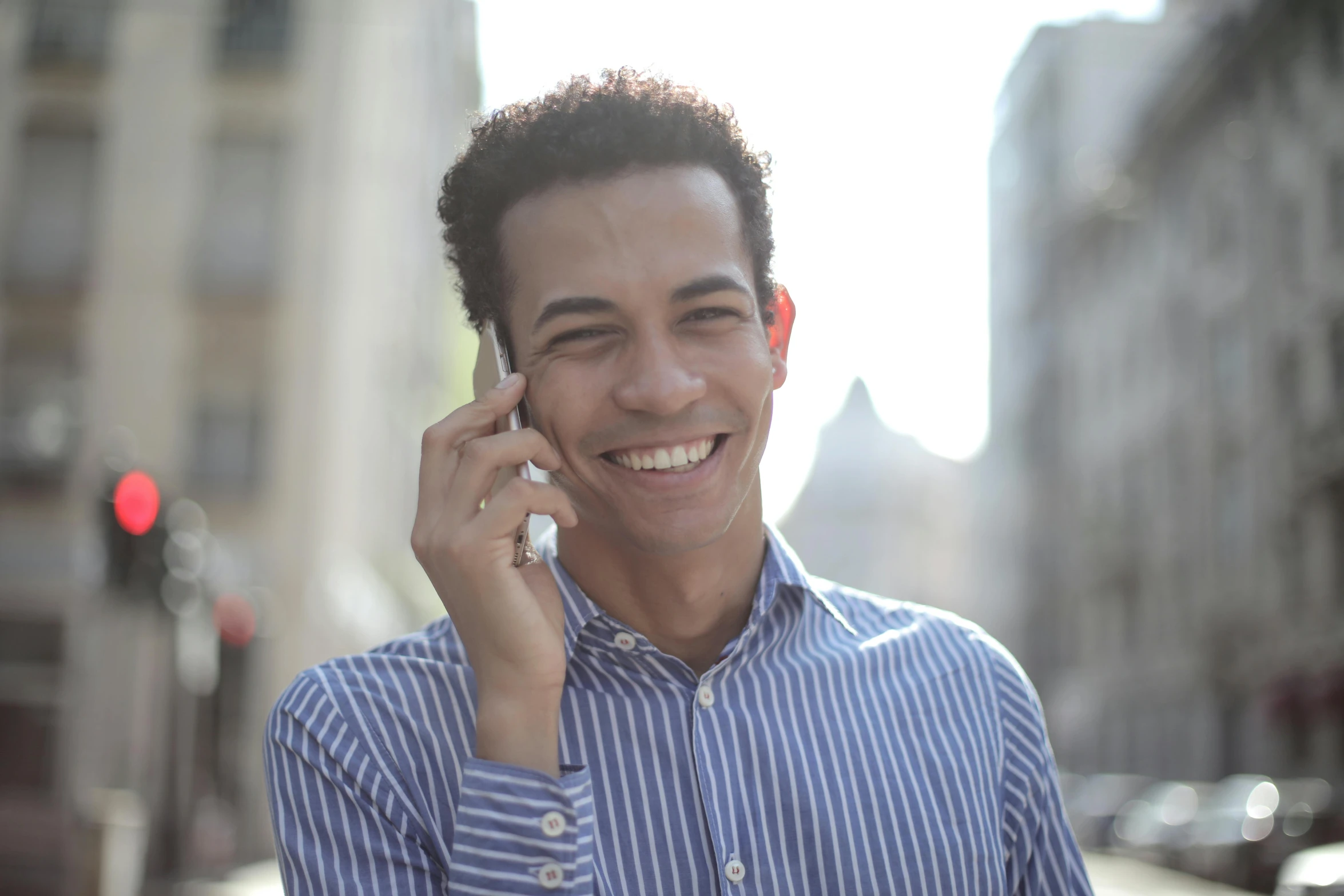 a man smiles while talking on a cell phone, a photo, aida muluneh, avatar image, cairo, rectangle